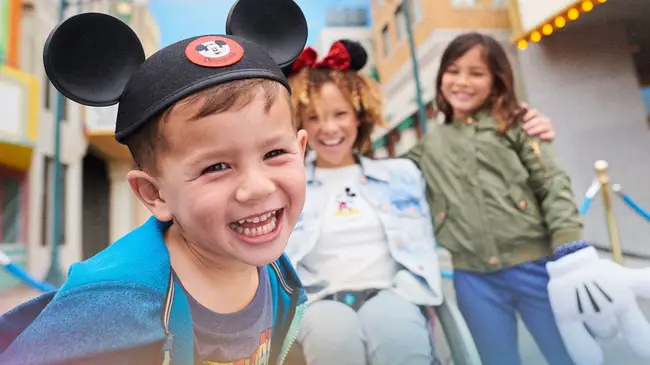 Tourists taking photos in front of Disney park attractions