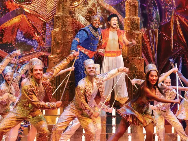 The glowing marquee of New Amsterdam Theatre at night