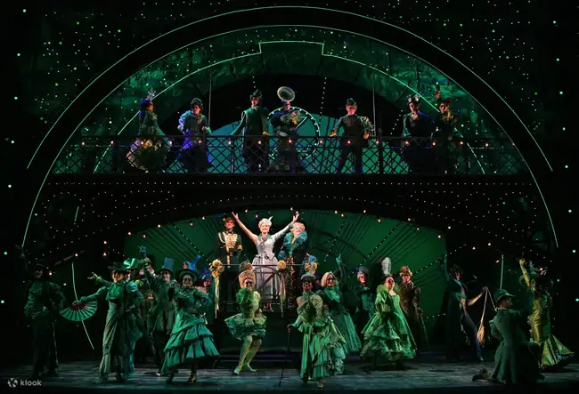 The green glowing stage of Gershwin Theatre during Wicked performance with the dragon