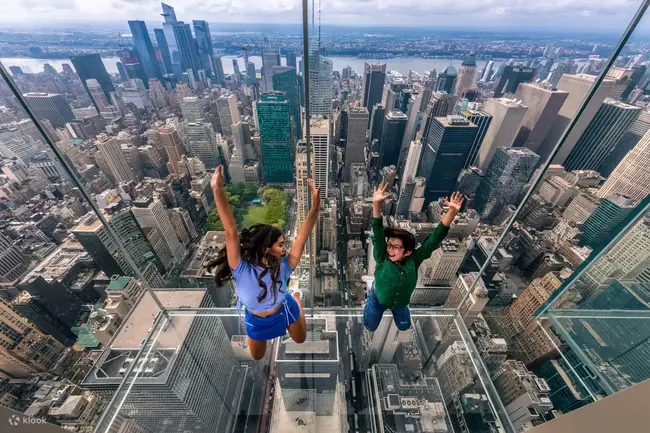 Visitors wearing shoe covers in the mirrored room